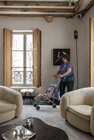 Sculpture of woman with pushchair in modern living room 