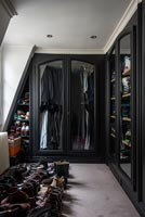Black painted wardrobe doors in walk-in wardrobe 