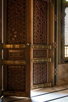 Ornate carved front door open into hallway 