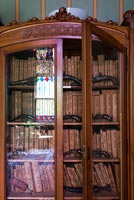 Detail of wooden cabinet filled with books 