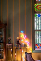 Colourful light from stained glass window hitting wall 