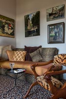 Animal print fabrics on furniture in eclectic living room 
