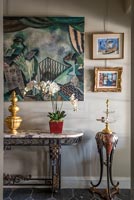 Eclectic hallway with paintings and ornaments 