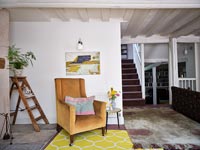 Country living room with modern yellow rug 