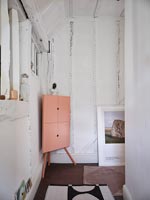 Modern pink corner cabinet in country hallway 