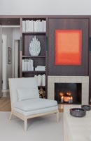 Modern living room with dark wood feature wall and fireplace 