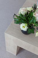 Detail of flowers on wooden coffee table 