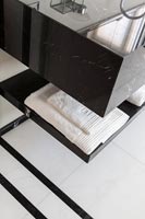 Detail of patterned flooring in black and white bathroom 