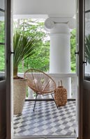 View of modern balcony with wicker chair 
