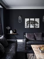 A triptych painting of hippo on black wall in modern living room 