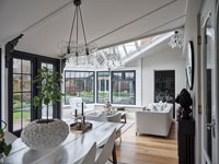 Modern dining room with view to living area in conservatory 