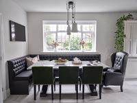 Black leather corner bench seating around dining table 