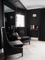 Black chairs in black painted bedroom 