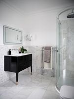 Modern bathroom - black sink unit and curved shower cubicle 