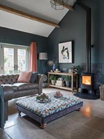 Modern country living room with lit wood burner 