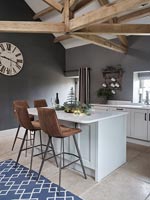 Barstools around modern kitchen island - decorated for Christmas 
