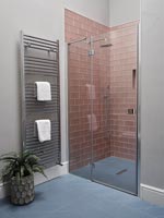 Modern bathroom with dusky pink tiling in shower cubicle 