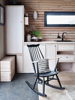 Black rocking chair in wooden modern country kitchen 