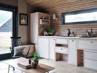 Wooden kitchen in small modern open plan living space 