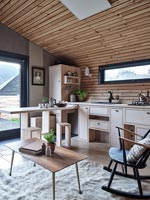 Modern wooden kitchen with pull out breakfast bar and stools 