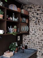 Exposed stone wall in modern country kitchen 