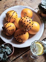 Orange and clove pomanders on table - detail 