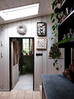 Country hallway with white painted wooden walls 