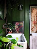 Sink in green painted country bathroom