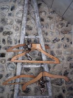 Detail of wooden clothes hangers on rustic ladder 