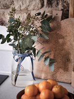 Flowers and foliage arrangement on kitchen worktop - detail 
