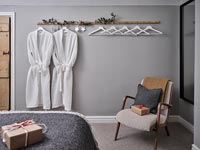 Matching dressing gowns on coat hooks in modern bedroom at Christmas time 