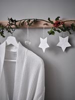 Wall mounted wooden hooks decorated for Christmas 