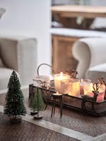 Christmas decorations and tealight candles on table 