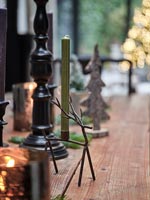 Small metal reindeer ornament on wooden dining table 