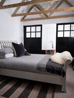 Modern country bedroom with view to en-suite bathroom 