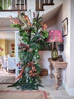 Large garland of plants and flowers in classic style hallway 