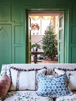 View through living room doors to hallway and Christmas tree 