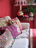 Detail of colourfully patterned cushions on sofa 