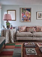 Country living room with mix of patterned fabrics 