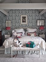 Pet dogs in modern country bedroom at Christmas time 