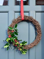 Simple Christmas wreath on grey painted front door 