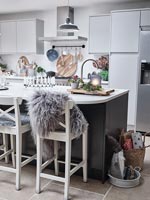 Modern kitchen with large island decorated for Christmas 