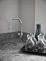 Drinking water tap in corner of modern kitchen worktop 