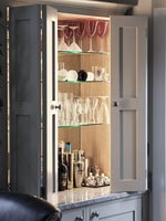 Drinks cabinet open to reveal mirrored shelving 