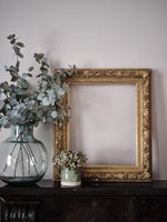 Gilded picture frame on mantelpiece 