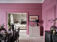 Pink painted walls in modern dining room 