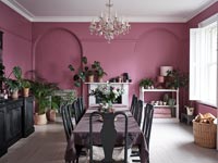 Modern dining room with pink painted walls and black furniture 
