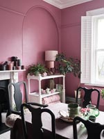 Modern dining room with pink painted walls 