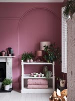 White shelf unit in pink painted alcove 