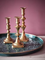 Brass candlesticks on decorative tray 